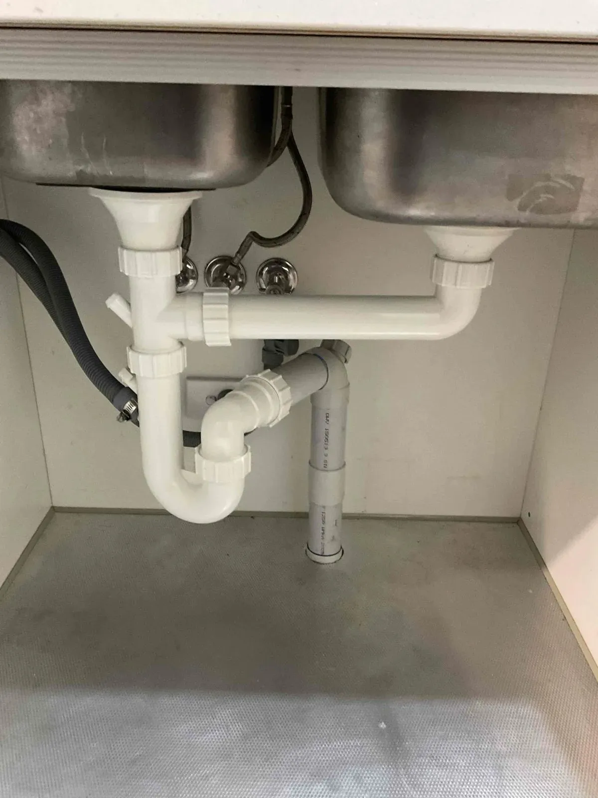 Kitchen sink waste pipes reconnected under the bench